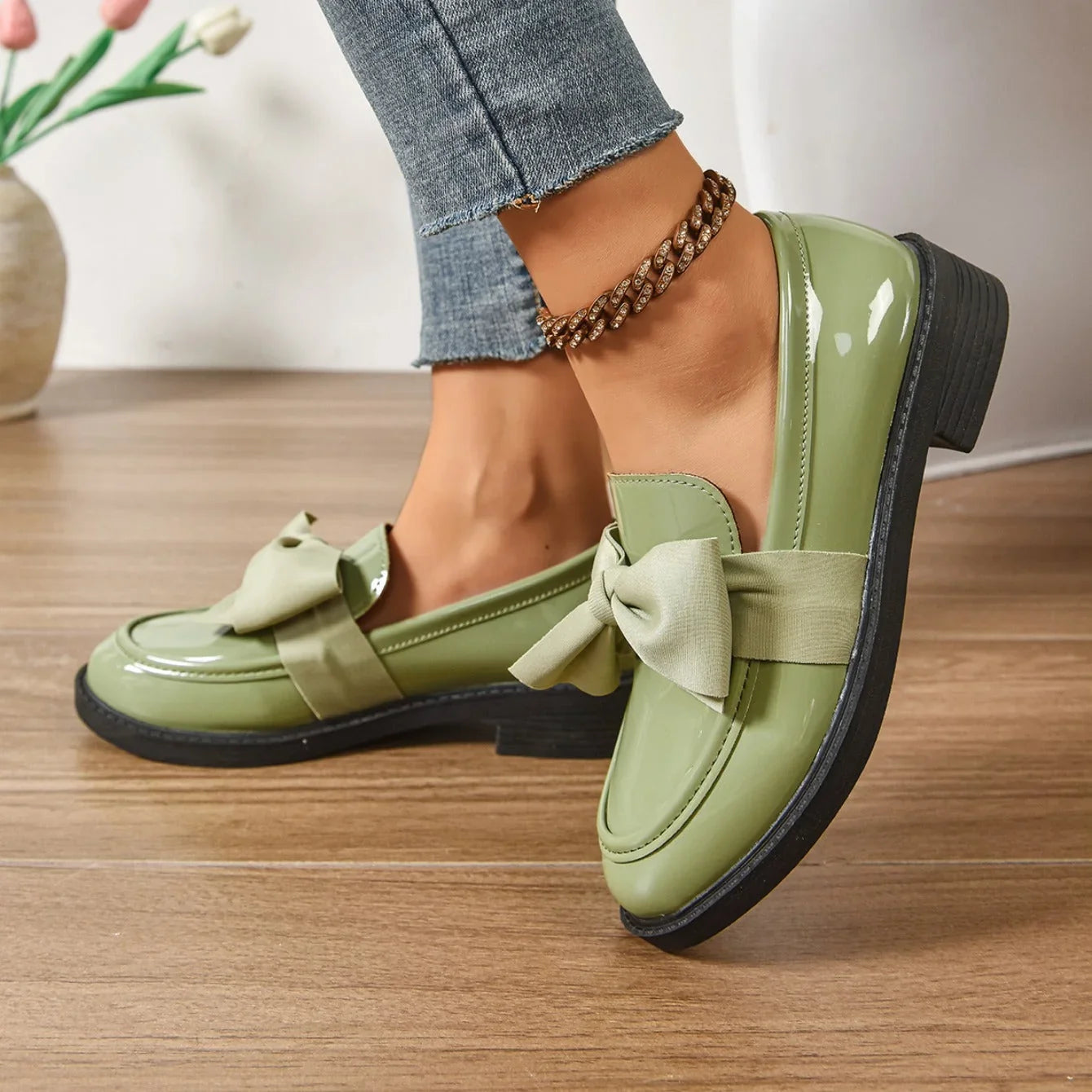 Bow detail loafers in glossy finish with contrast bow accent close-up