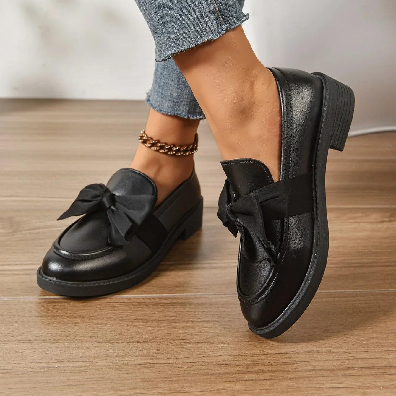 Side view of women's patent loafers with low block heel and slip-on design