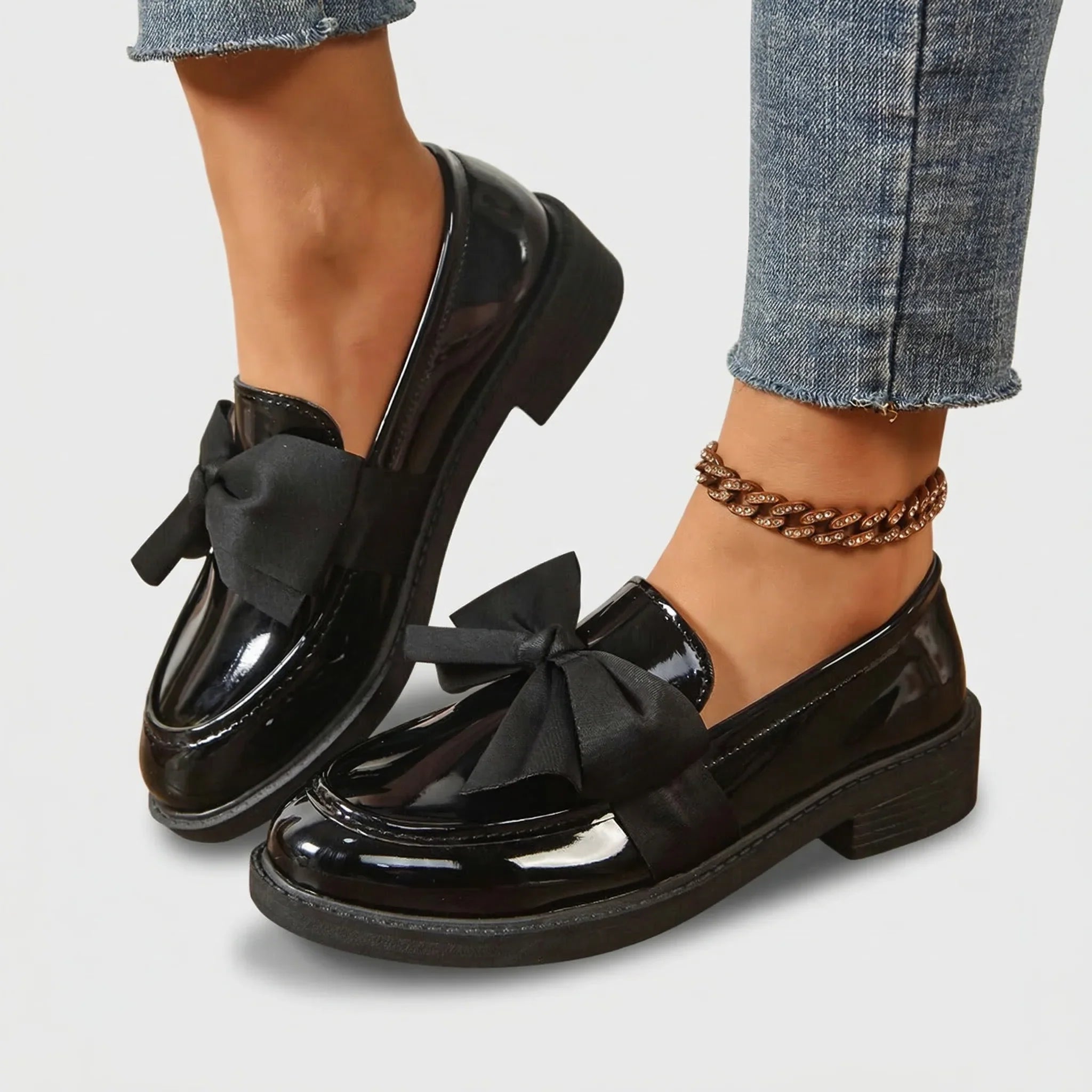 Women's glossy loafers with decorative bow on vamp and structured upper