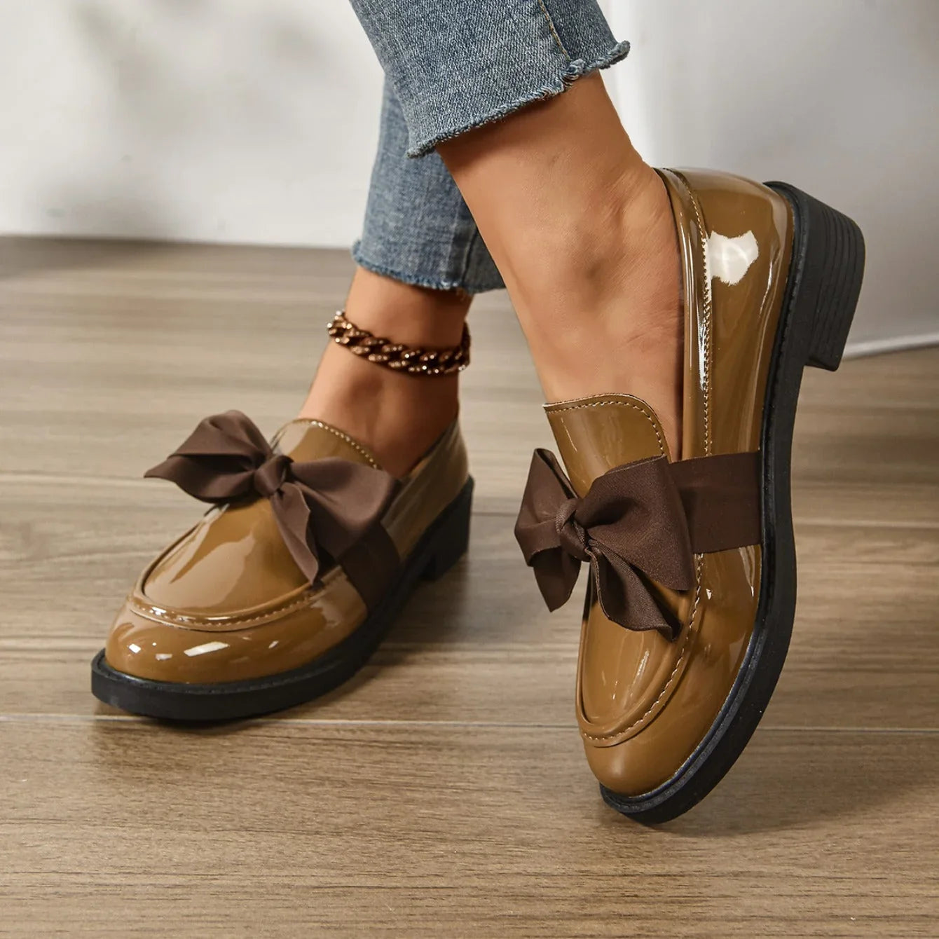 Detail shot of loafers showing smooth patent finish and contrast stitching
