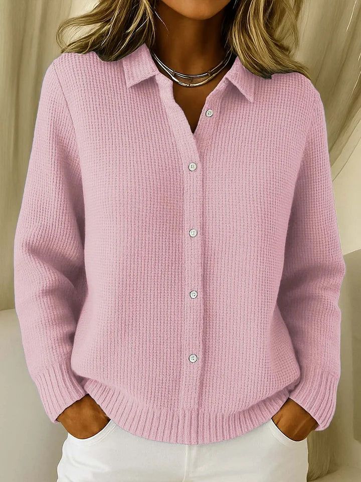 Close-up view of collared knit cardigan showing structured collar and button-front detail