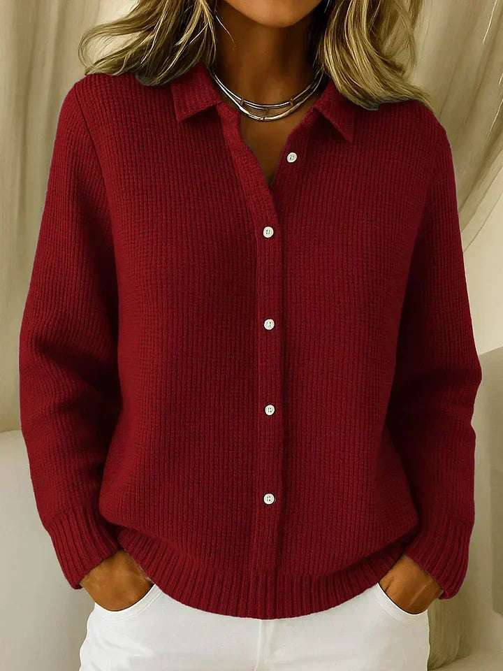 Side view of relaxed-fit knit cardigan displaying mid-hip length and ribbed construction
