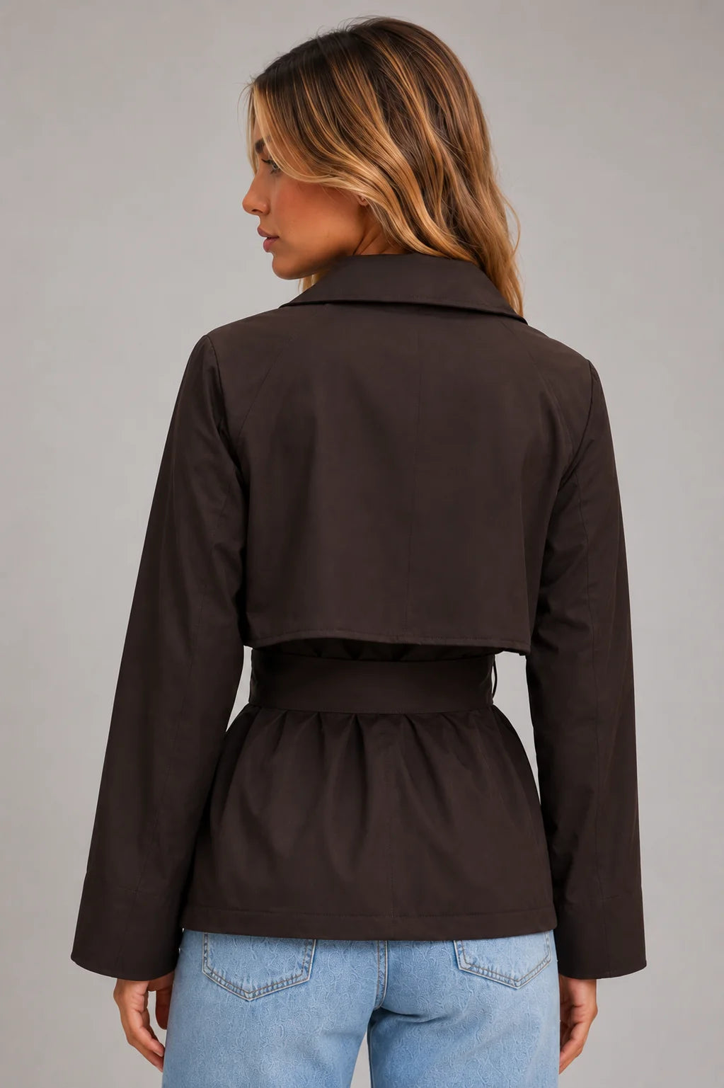 Women's cropped trench jacket styled with casual denim showcasing versatile layering and relaxed fit