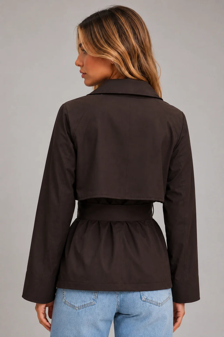 Women's cropped trench jacket styled with casual denim showcasing versatile layering and relaxed fit