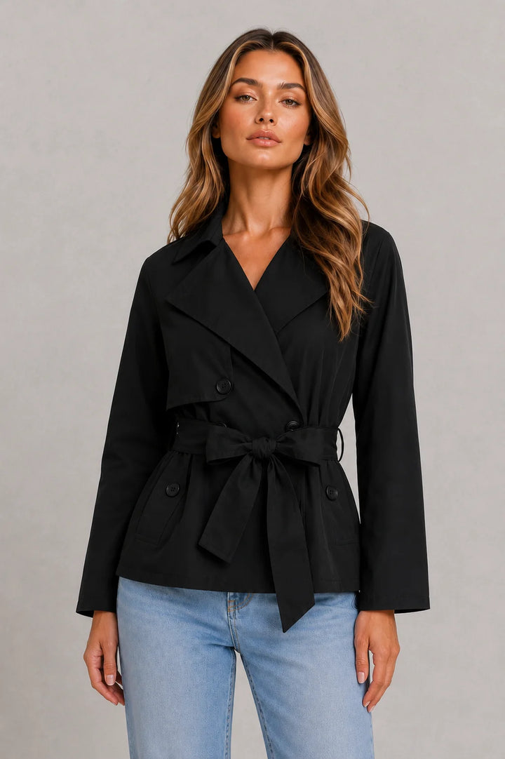 Full-length view of beige cropped trench jacket demonstrating double-breasted design and tailored construction