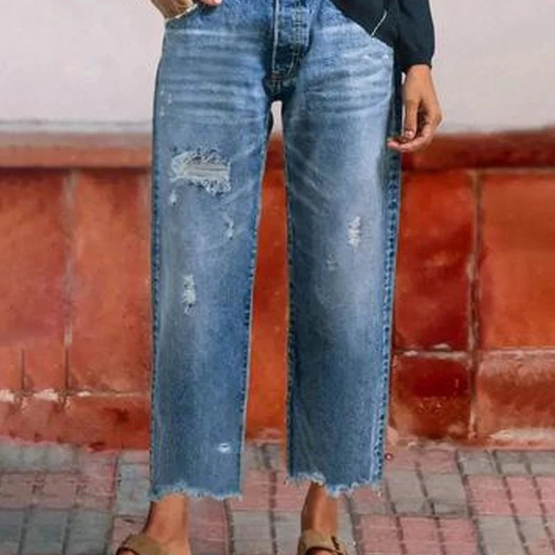 Front detail of high-waist cropped jeans with button-fly and pockets