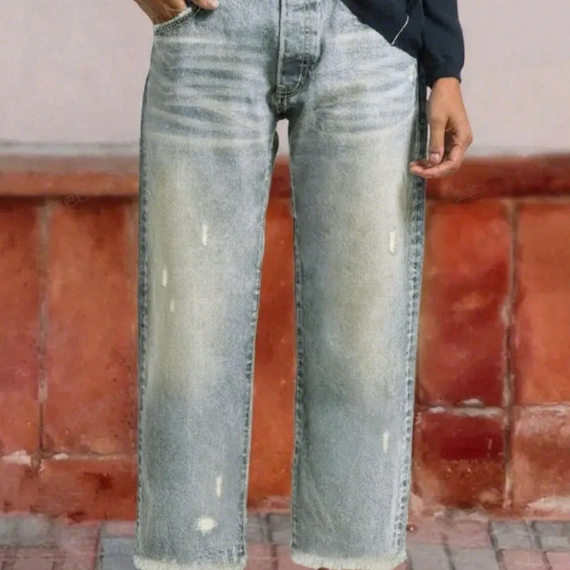 Side profile of wide-leg jeans showing relaxed silhouette and cropped length