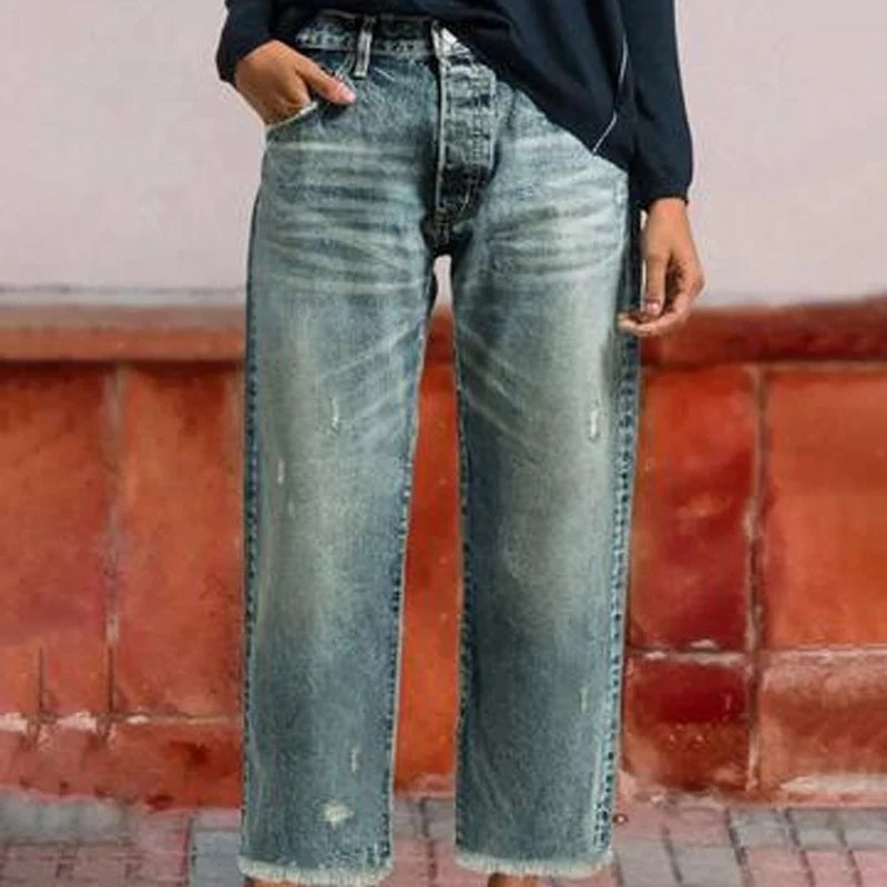 Woman wearing distressed cropped jeans with raw hem and casual styling