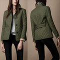 Front view of women's quilted jacket in olive green with diamond stitching and button closure