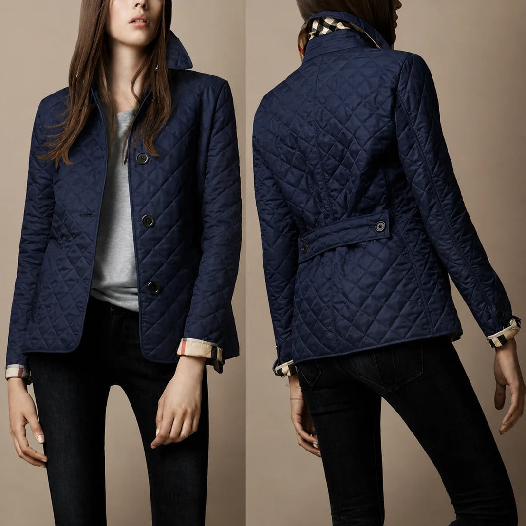Side angle of women's quilted jacket with structured collar and tailored fit