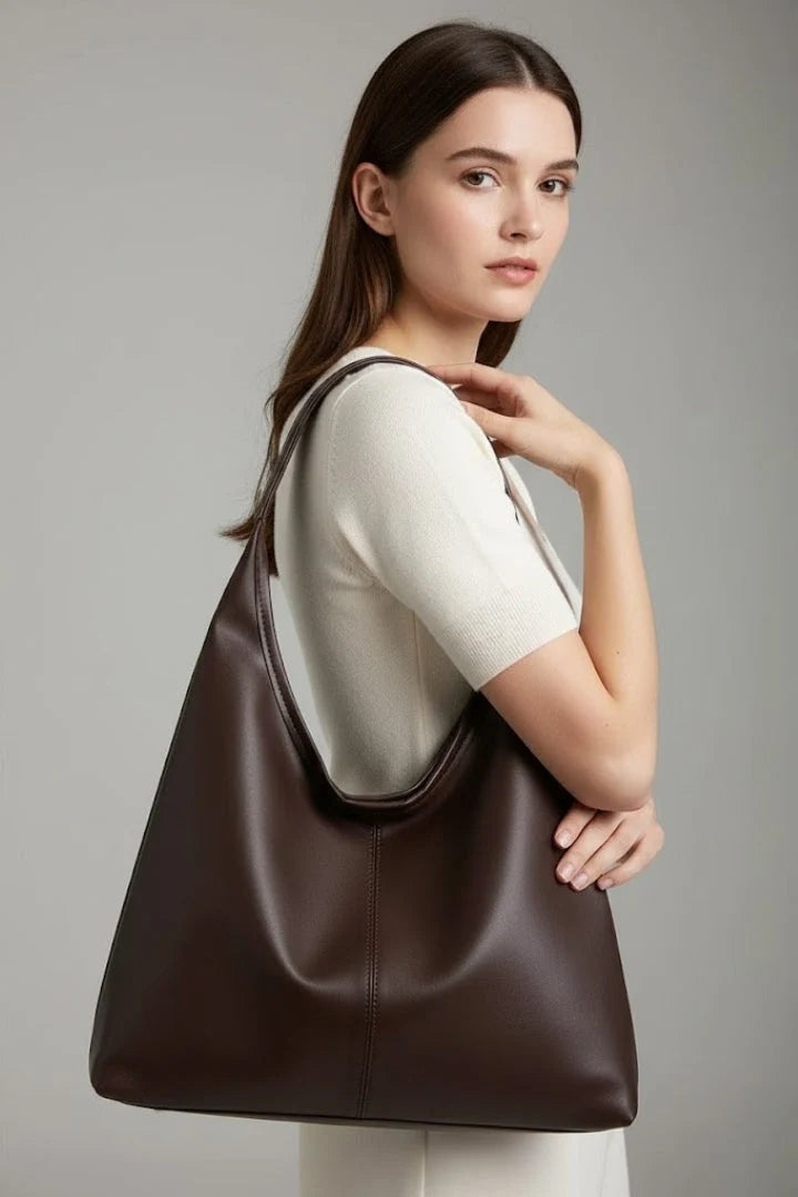 Close-up of knotted strap detail and smooth finish on women's slouchy hobo bag