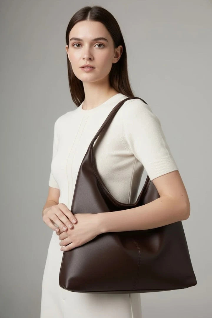 Front view of women's slouchy shoulder bag in neutral brown with minimalist design