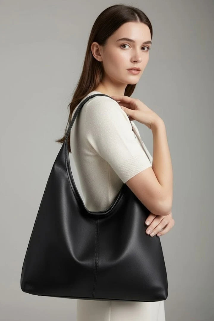 Adjustable shoulder strap and knotted accent detail on women's minimalist hobo bag