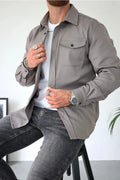 Men's casual overshirt in grey with relaxed fit and chest pocket detail worn over white tee