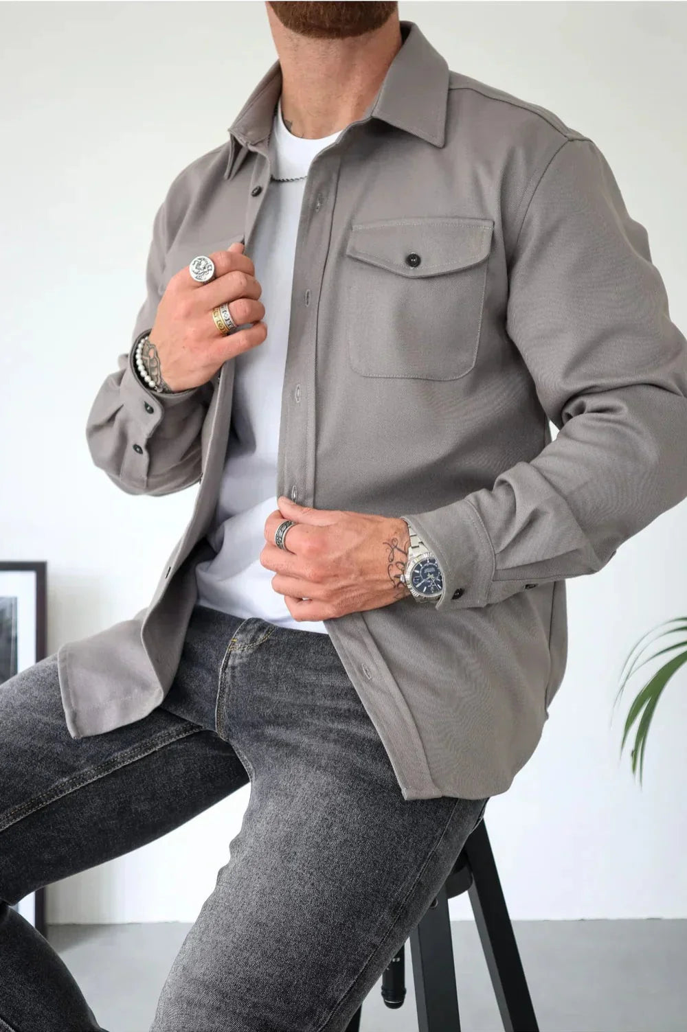 Men's casual overshirt in grey with relaxed fit and chest pocket detail worn over white tee