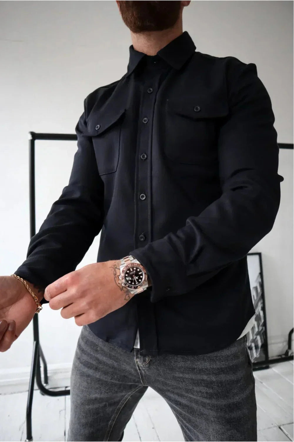 Detail of smooth fabric finish and relaxed cut on men's overshirt