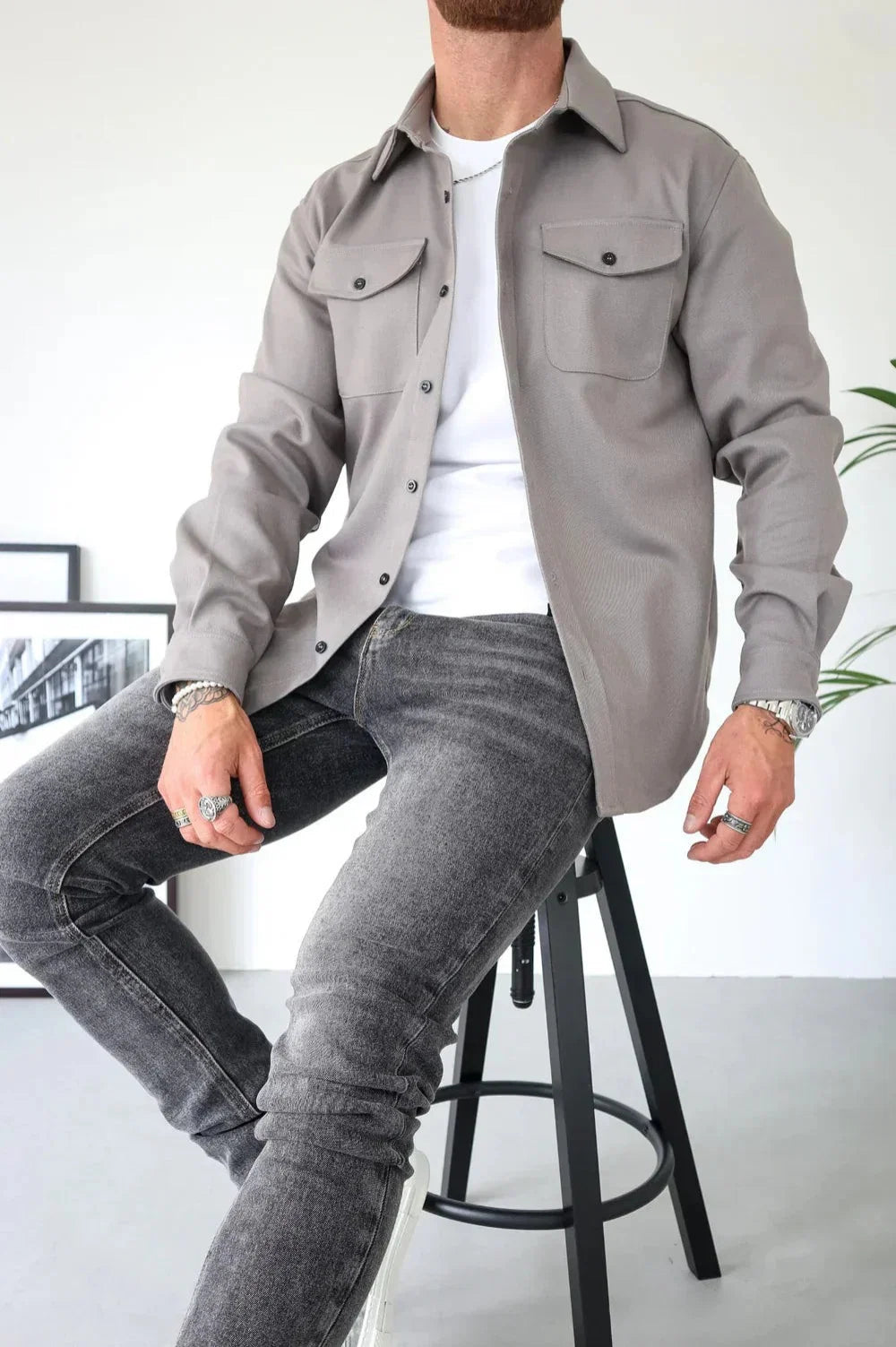 Close-up of men's overshirt showing structured fabric and button-through fastening with classic collar