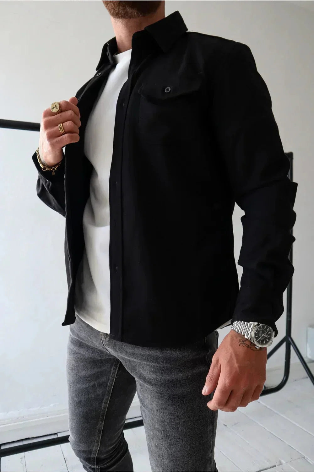 Men's grey overshirt styled with dark jeans for casual layering look