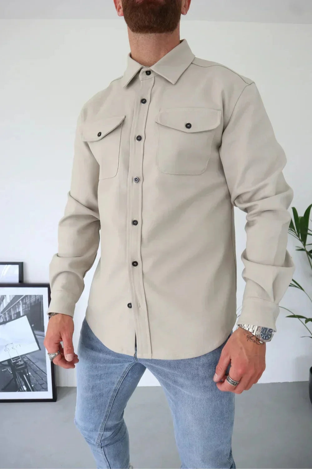 Close-up of button fastening and collar detail on men's casual overshirt