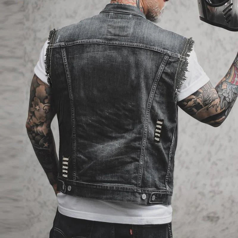 Side angle of men's distressed denim vest featuring decorative stitching and washed finish