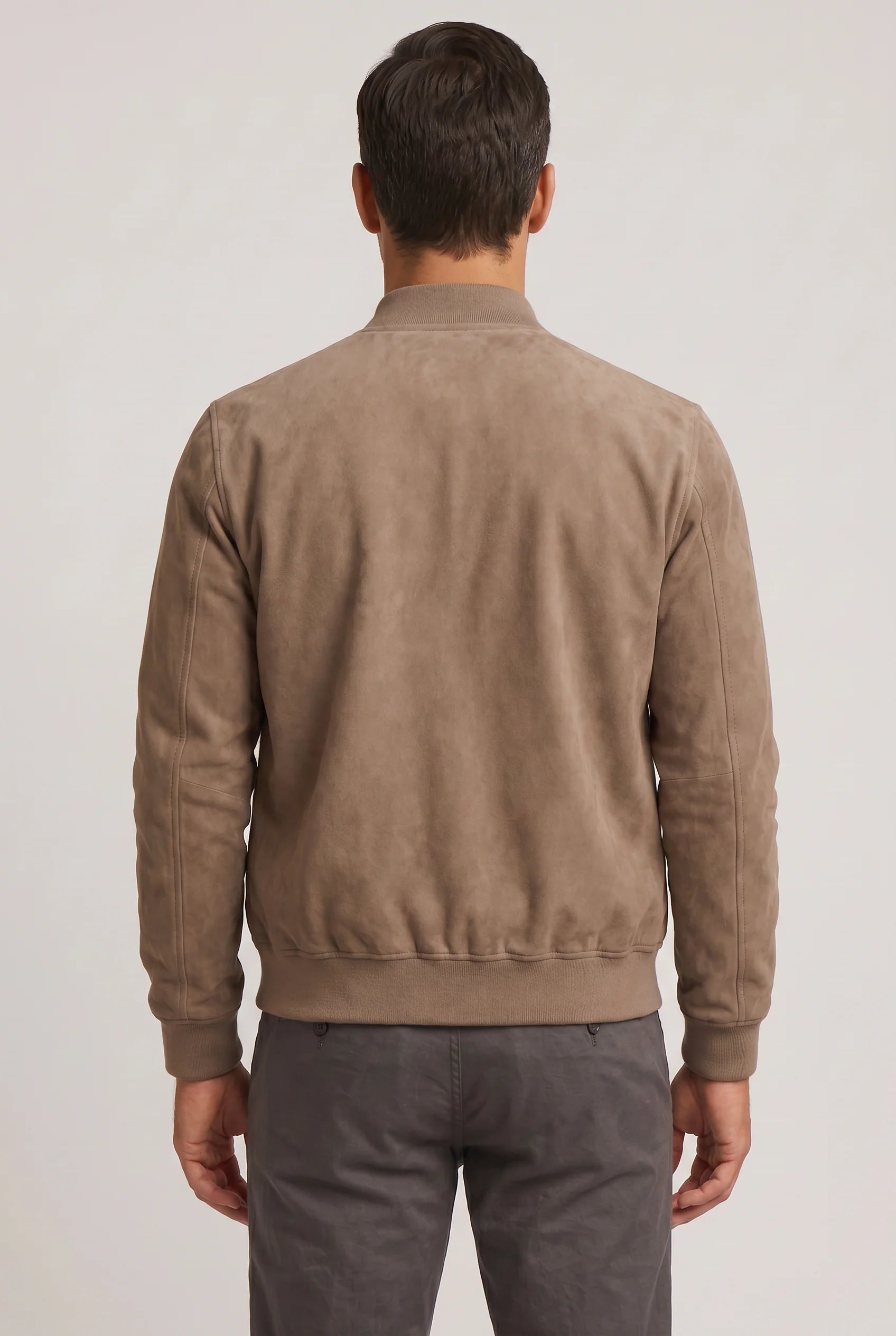Close-up of men's bomber jacket showing soft suede finish and front zip closure detail