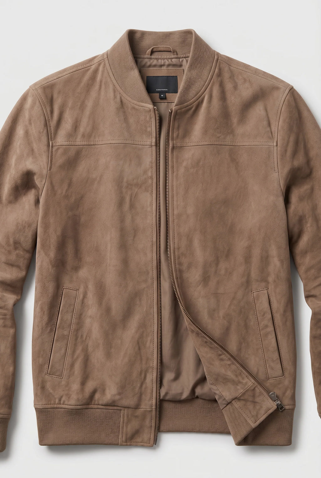Side profile of men's suede bomber jacket displaying tailored fit and hip-length silhouette