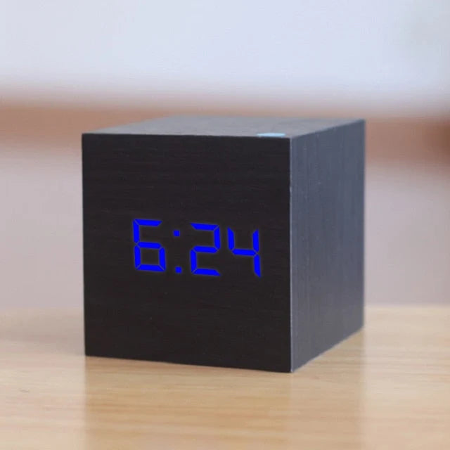 Modern square alarm clock with LED display showing temperature and date functions