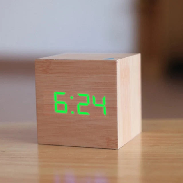 Square alarm clock with automatic dimming display for nighttime use on bedside table