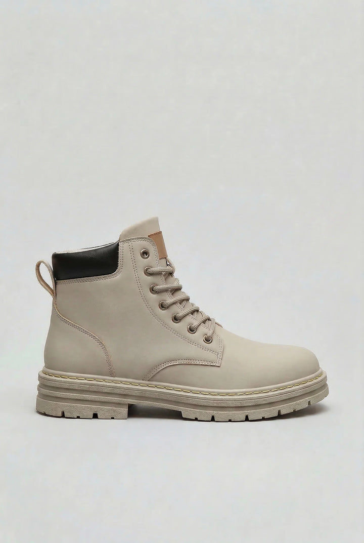 Men's lace-up boots with chunky lug sole in light grey, side profile view showing high ankle design