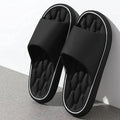 Men's massage slides in black with ridged footbed and white contrast trim on sole
