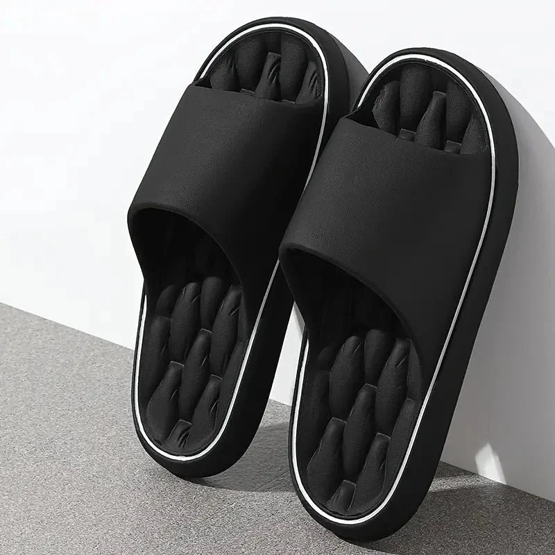 Men's massage slides in black with ridged footbed and white contrast trim on sole