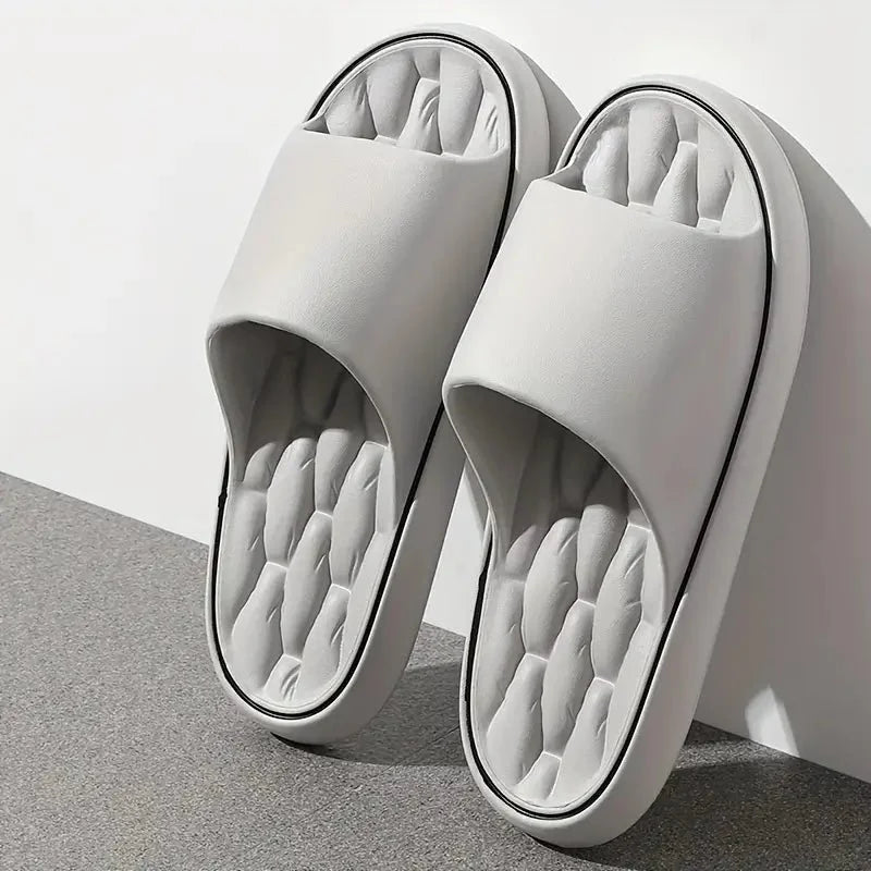 Close-up view of men's massage slides showing textured ridged insole and cushioned footbed