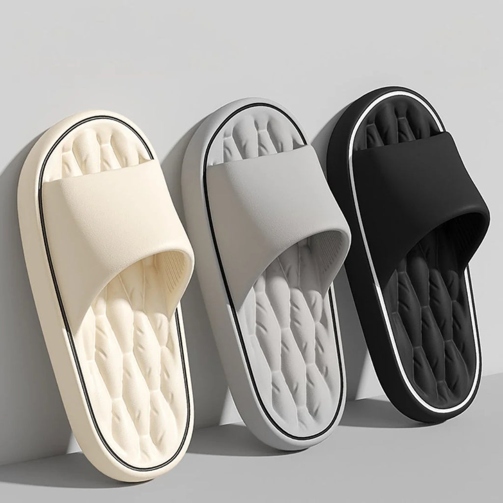 Overhead view of men's black massage slides displaying wide strap and massaging ridges