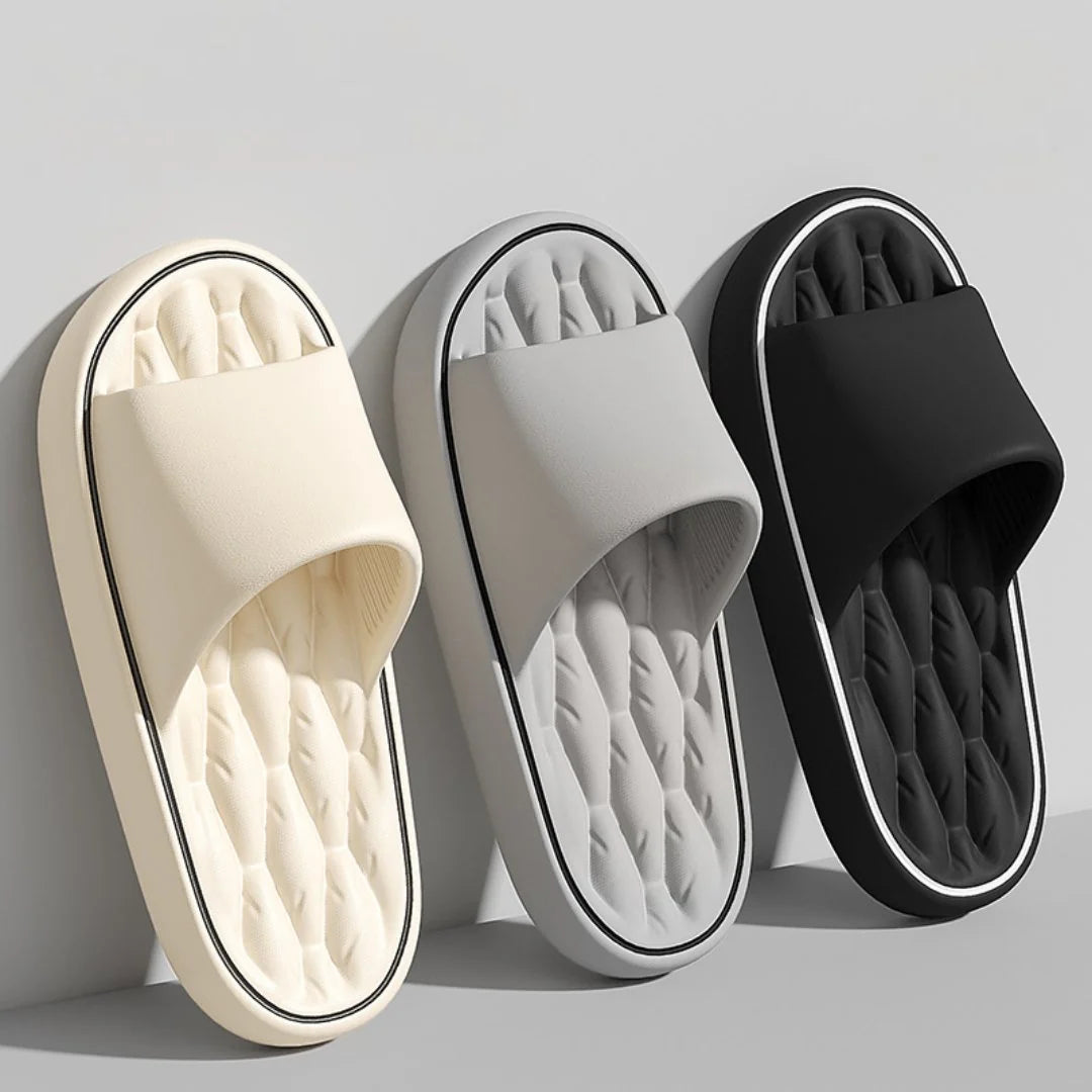 Overhead view of men's black massage slides displaying wide strap and massaging ridges