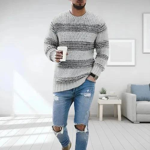 Side view of men's striped jumper displaying relaxed fit and ribbed cuffs detail