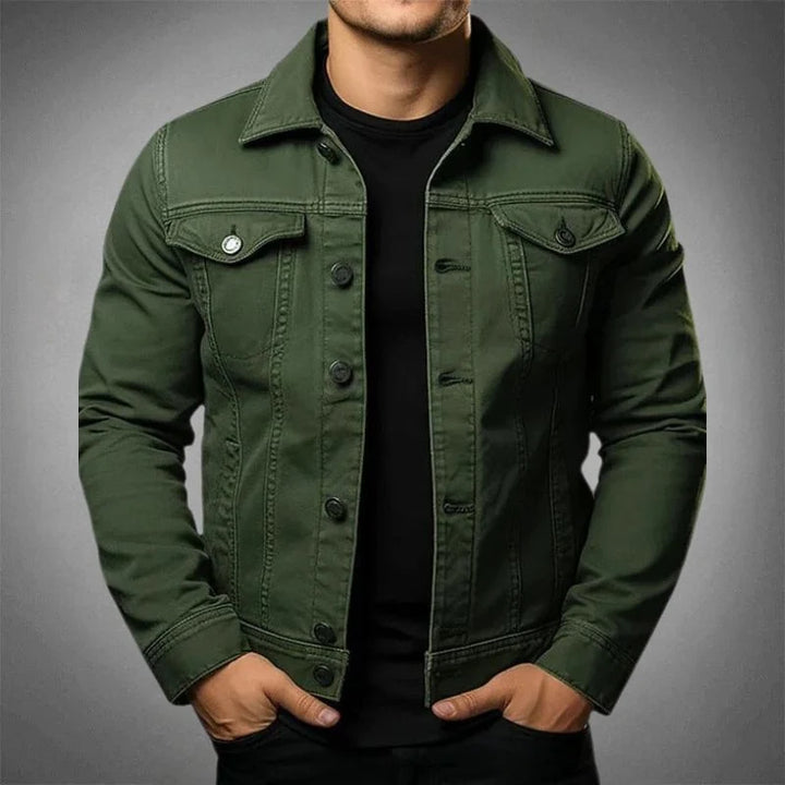 Detail shot of men's denim jacket chest pocket with button flap and contrast stitching