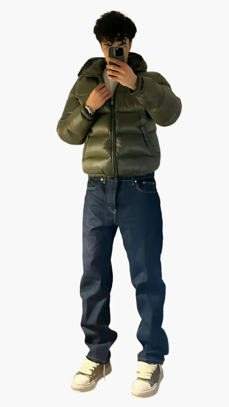 Front view of men's quilted puffer jacket showing shiny finish, high collar, and relaxed fit silhouette