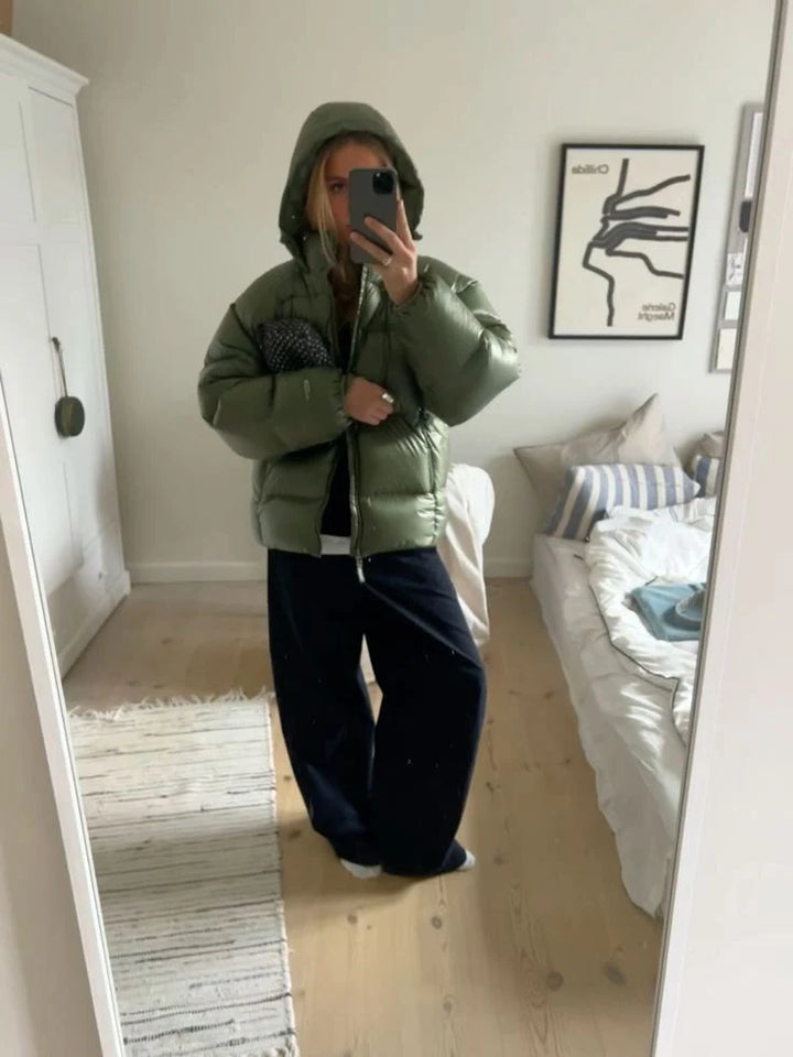 Close-up detail of men's puffer jacket hood adjustment and quilted horizontal panel construction