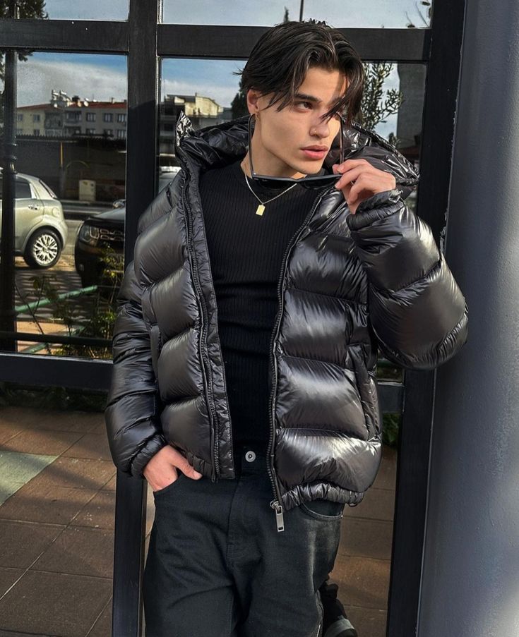 Rear view of men's puffer jacket displaying cropped length and structured quilted design