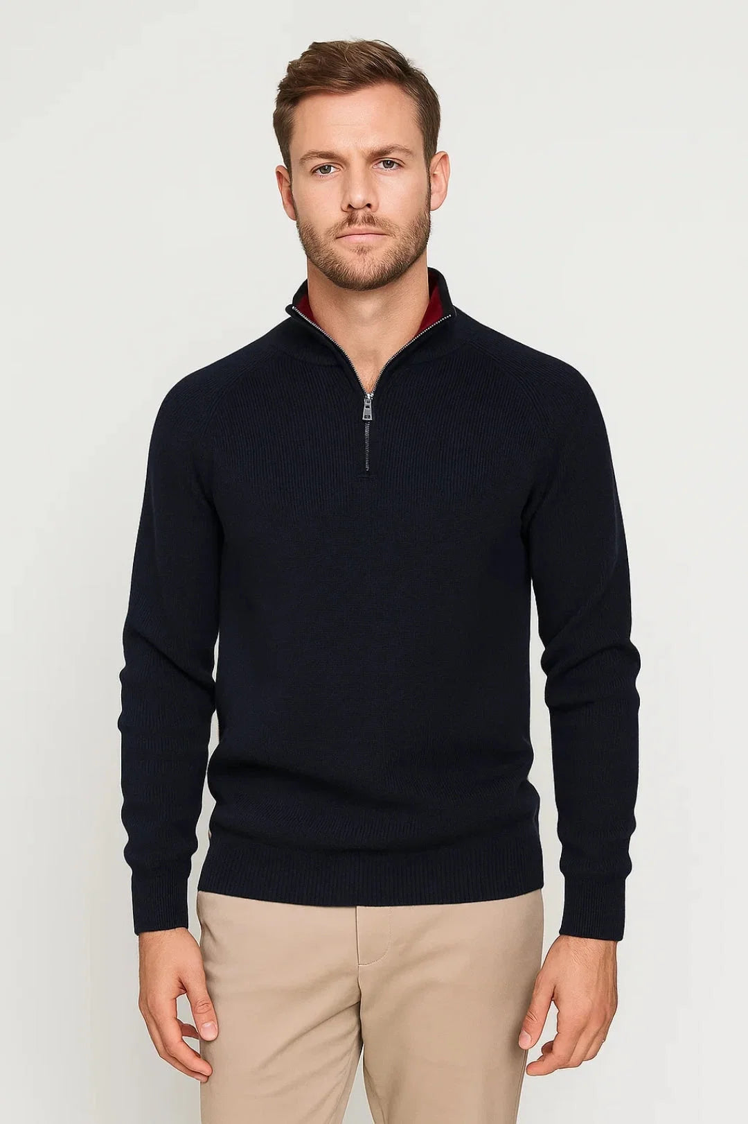 Men's quarter-zip knit jumper in navy with ribbed texture and stand collar worn with beige chinos