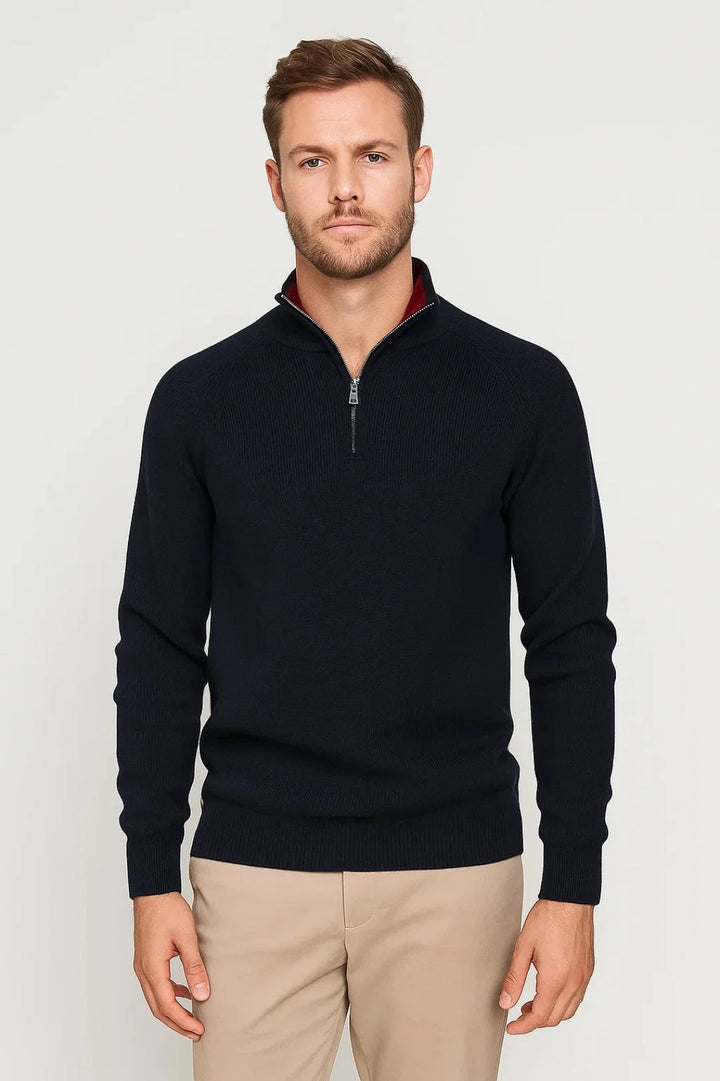 Men's quarter-zip knit jumper in navy with ribbed texture and stand collar worn with beige chinos