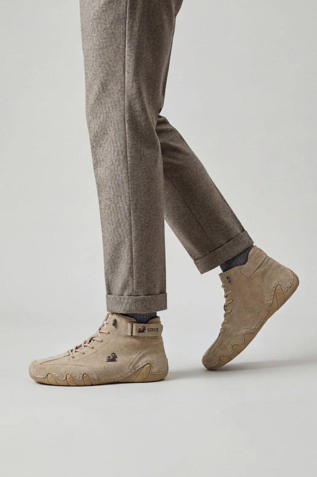 Side view of men's high-top trainers showing structured ankle strap and perforated detailing