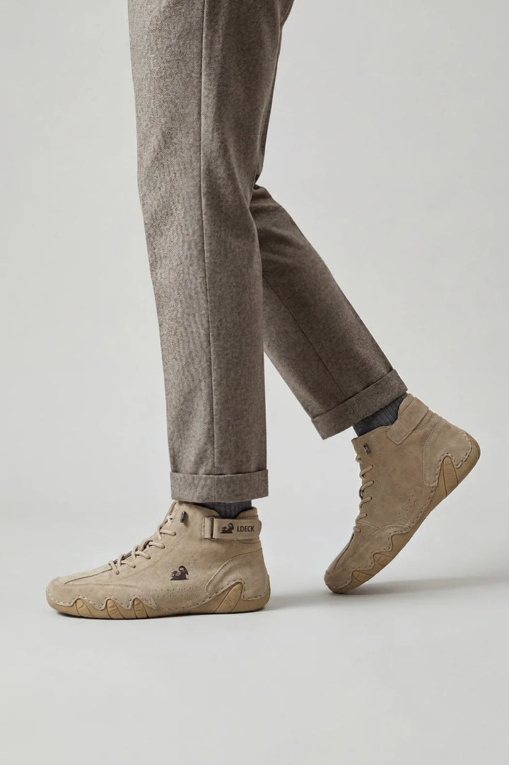Side view of men's high-top trainers showing structured ankle strap and perforated detailing