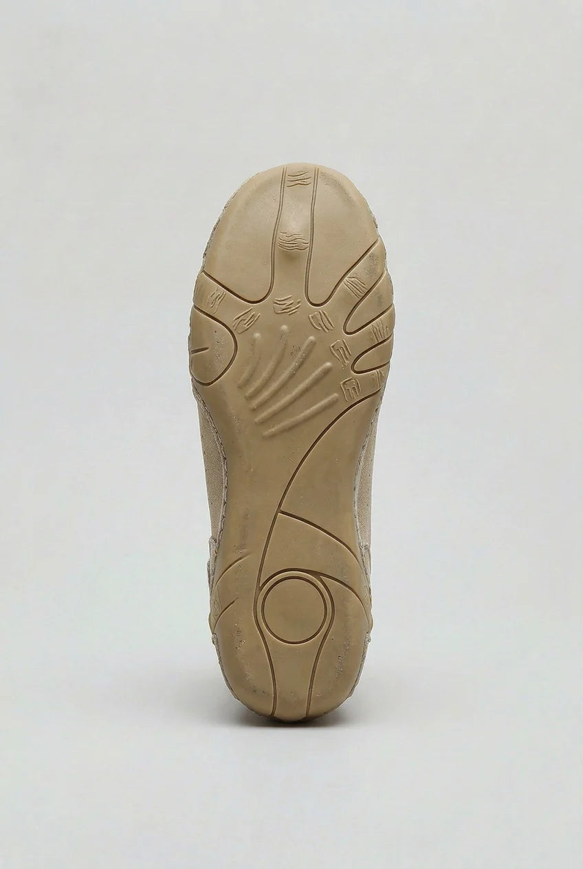 Close-up of men's high-top trainers displaying sculpted rubber outsole and reinforced toe