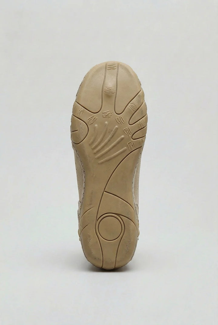 Close-up of men's high-top trainers displaying sculpted rubber outsole and reinforced toe