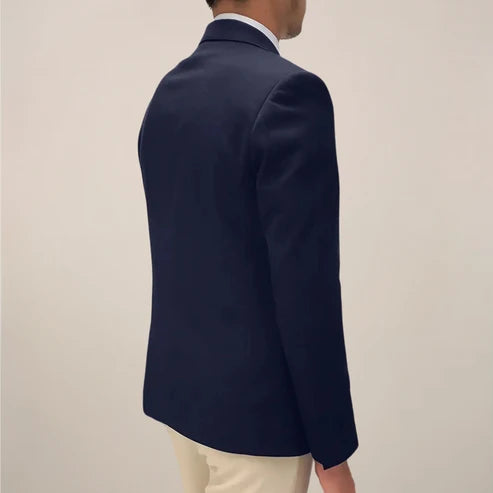 Full-length view of men's navy single-breasted blazer paired with cream trousers for smart casual styling