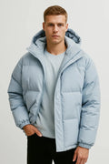 Men's puffer jacket in light blue with hooded design and quilted construction for winter wear