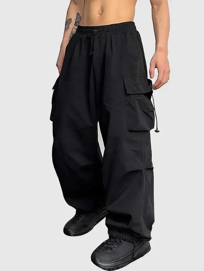 Men's wide leg cargo trousers in black with multiple pockets and elasticated waist