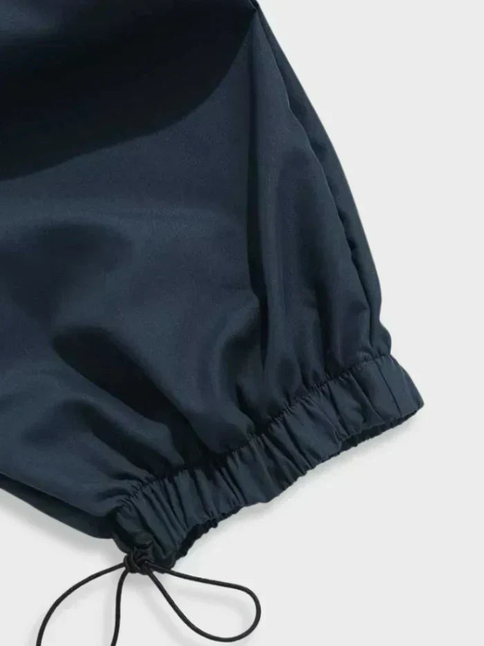 Rear view of black cargo trousers showing elasticated waistband and relaxed fit