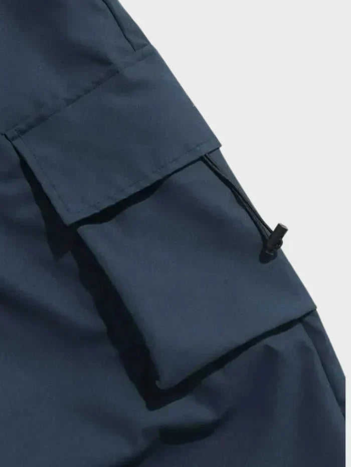 Full length view of men's oversized cargo trousers with drawstring waist closure
